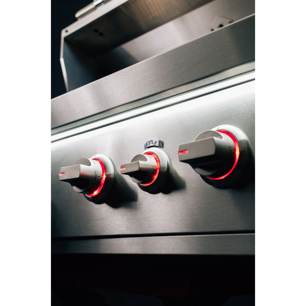 Summerset Quest 36" Grill stainless steel control panel with three knobs and red illuminated burner indicators